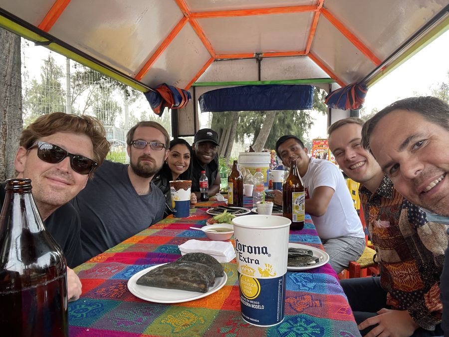 Attendees at a long table aboard a decorated boat