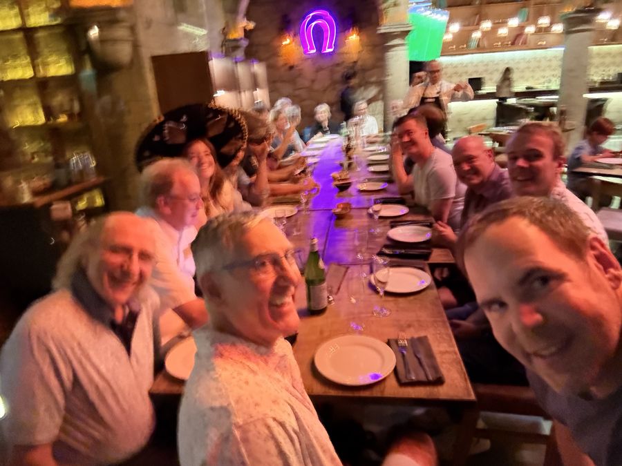 A long dinner table in a stone-walled restaurant
