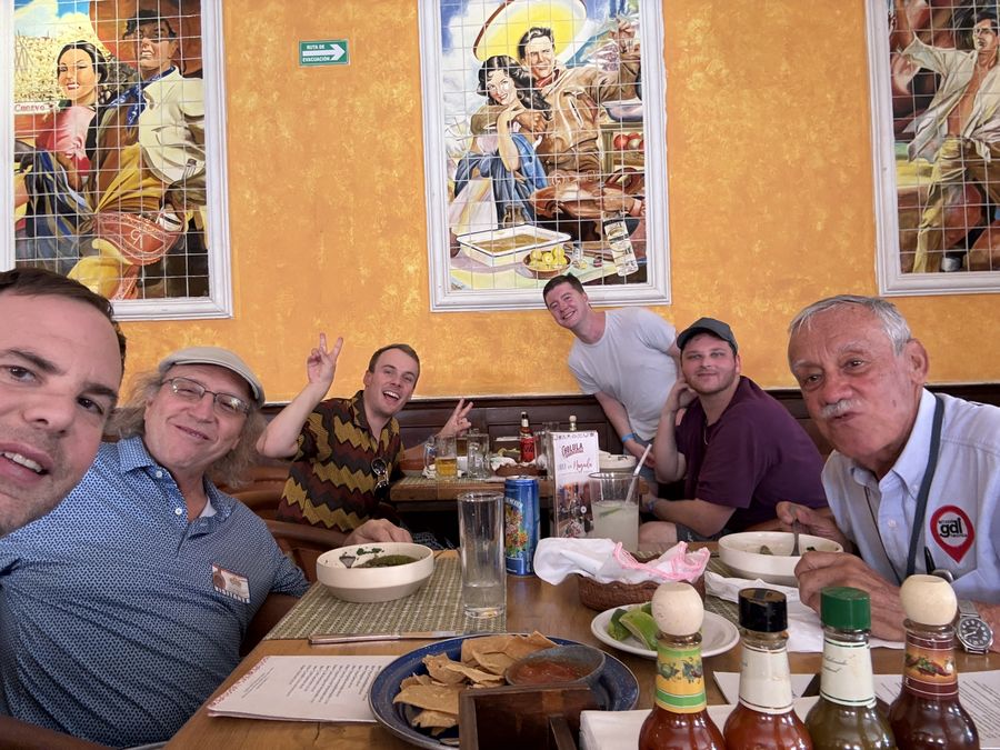 A group at a restaurant with painted tile murals