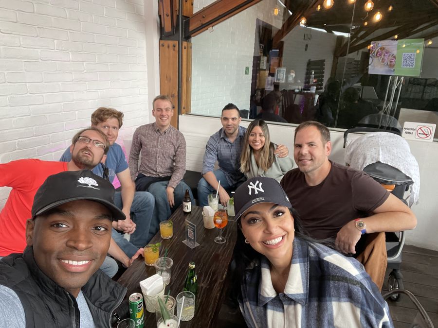 Attendees gathered with drinks on a covered patio