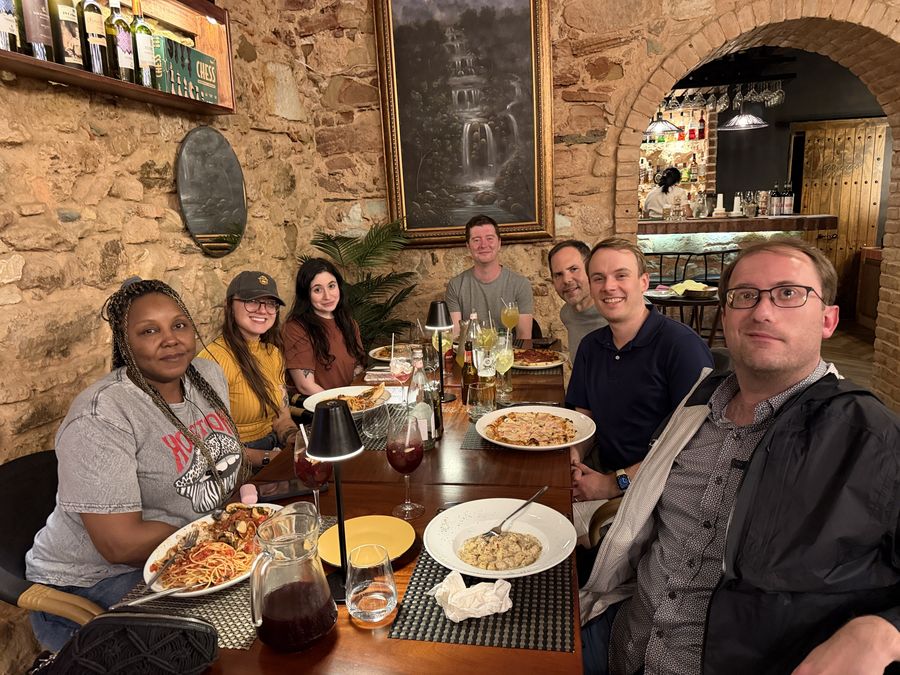 A group at dinner in a restaurant with stone walls